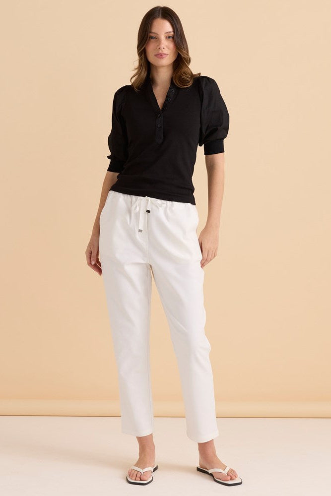 Image of a model wearing Pants. Product name - Kenzie Jogger White in White colour by brand - Betty Basics