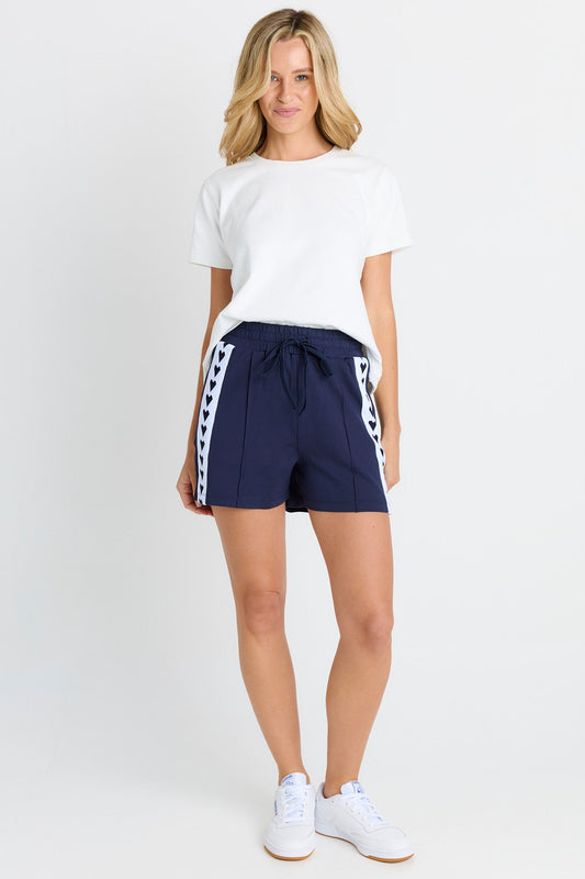 Image of a model wearing Shorts. Product name - Jamie Shorts Navy in Navy colour by brand - Betty Basics