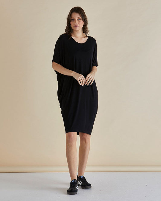 Image of a model wearing Tops. Productname: Betty Basics Maui T-Shirt Dress Black in Black colour by brand - Betty Basics