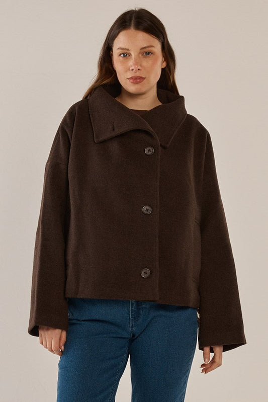 Image of a model wearing Outerwear. Product name - Prue Pea Coat Chocolate in Chocolate colour by brand - Betty Basics
