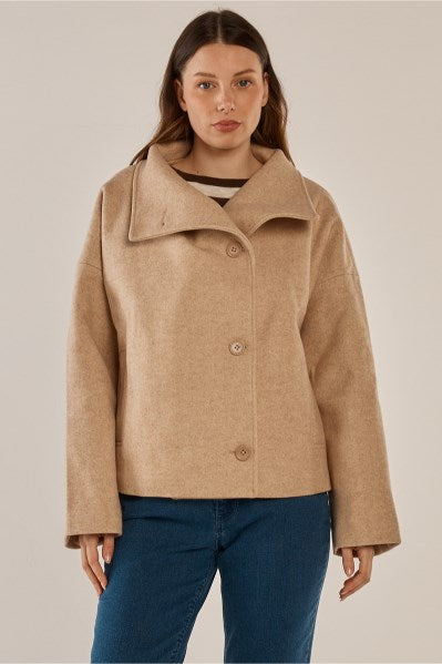 Image of a model wearing Outerwear. Product name - Prue Pea Coat Cream in Cream colour by brand - Betty Basics