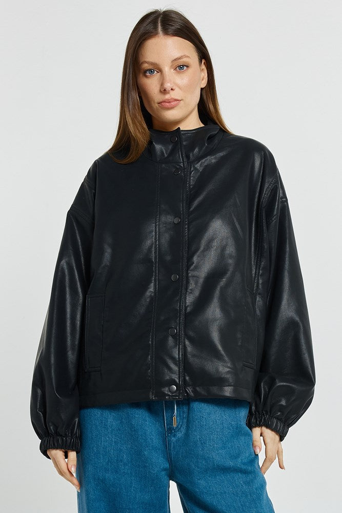 Image of a model wearing Outerwear. Product name - Polly PU Jacket Black PU in Black Pu colour by brand - Betty Basics