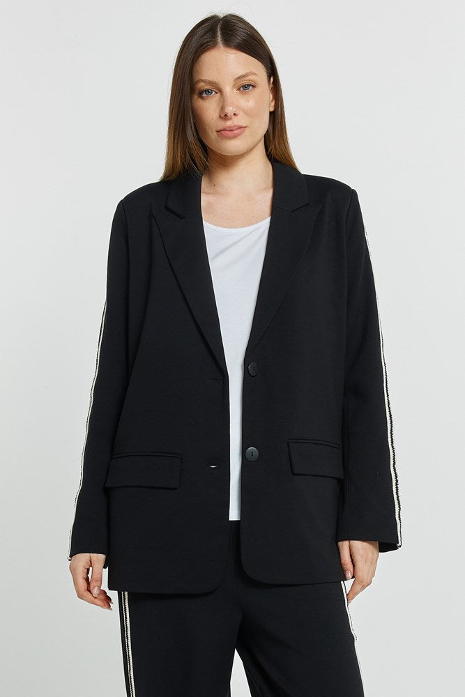 Image of a model wearing Outerwear. Product name - Bronwyn Blazer Black in Black colour by brand - Betty Basics