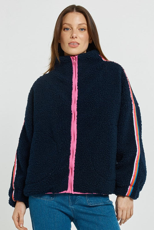 Image of a model wearing Outerwear. Product name - Aubrey Fleece Jacket Navy/Rainbow in Navy/Rainbow colour by brand - Betty Basics