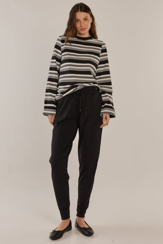 Image of a model wearing Pants. Productname: Betty Basics Cara Travel Jogger Black in Black colour by brand - Betty Basics