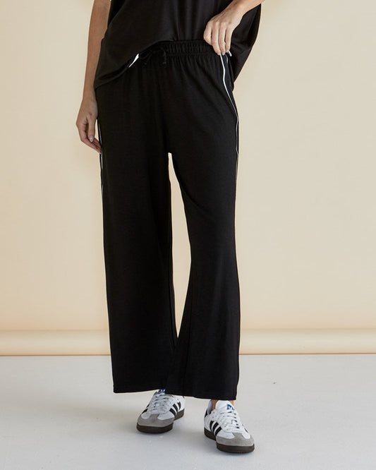 Image of a model wearing Pants. Productname: Betty Basics Evelyn Wide Leg Jogger Black in Black colour by brand - Betty Basics