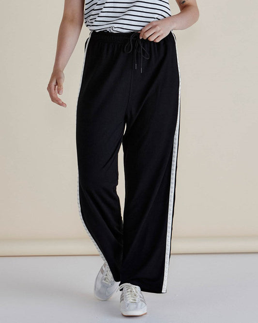 Image of a model wearing Pants. Productname: Betty Basics Evelyn Wide Leg Jogger Black Trim in Black Trim colour by brand - Betty Basics