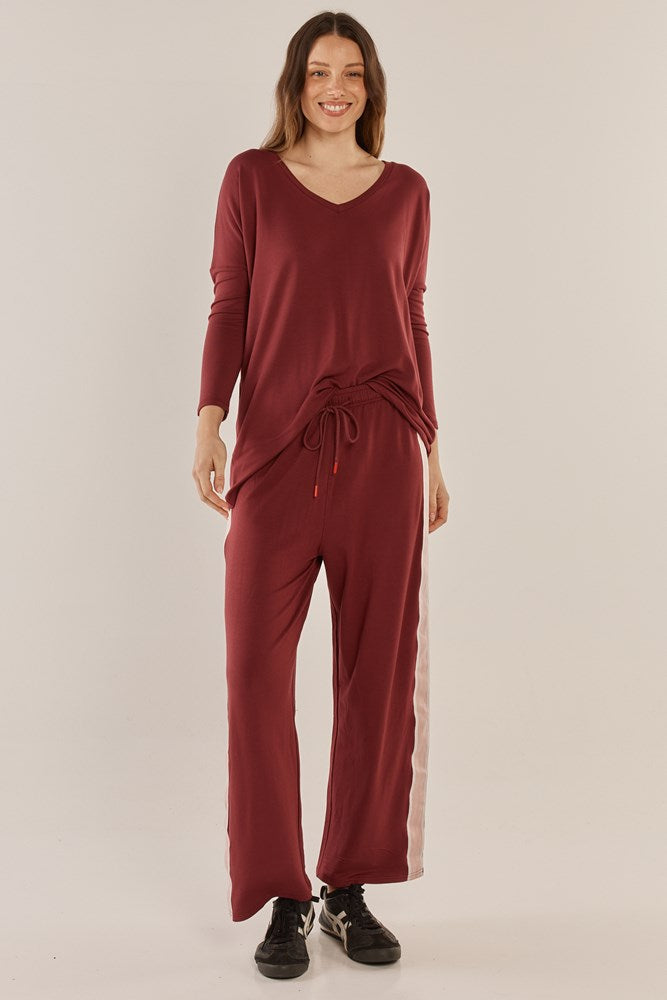 Image of a model wearing Pants. Productname: Betty Basics Evelyn Wide Leg Jogger Burgundy in Burgandy colour by brand - Betty Basics