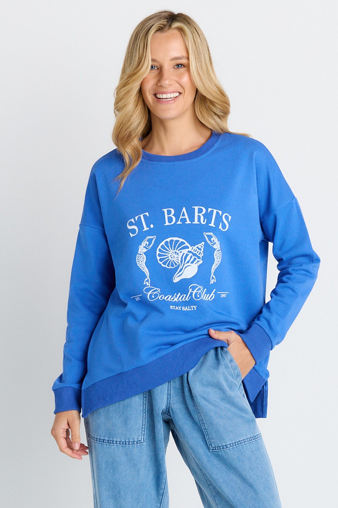 Image of a model wearing Outerwear. Product name - Palma Sweat in St Barts Print colour by brand - Betty Basics