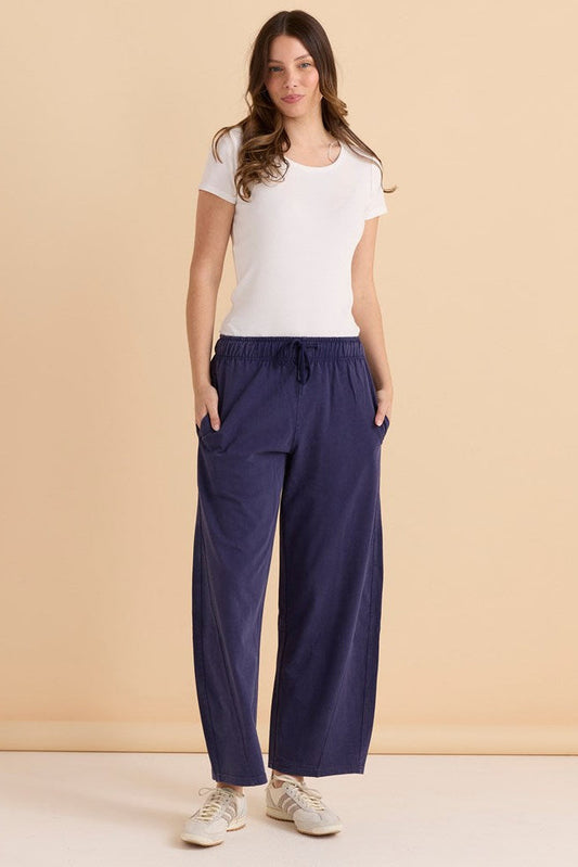 Image of a model wearing Pants. Productname: Betty Basics Barrel Leg Sweatpant Navy in Navy colour by brand - Betty Basics