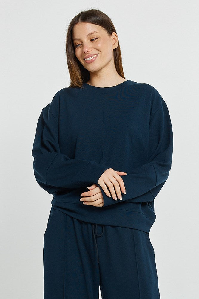 Image of a model wearing Outerwear. Product name - Elona Top Navy in Navy colour by brand - Betty Basics