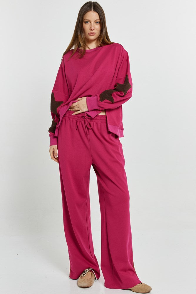 Image of a model wearing Pants. Product name - Saskia Trackpant Mulberry in Mulberry colour by brand - Betty Basics