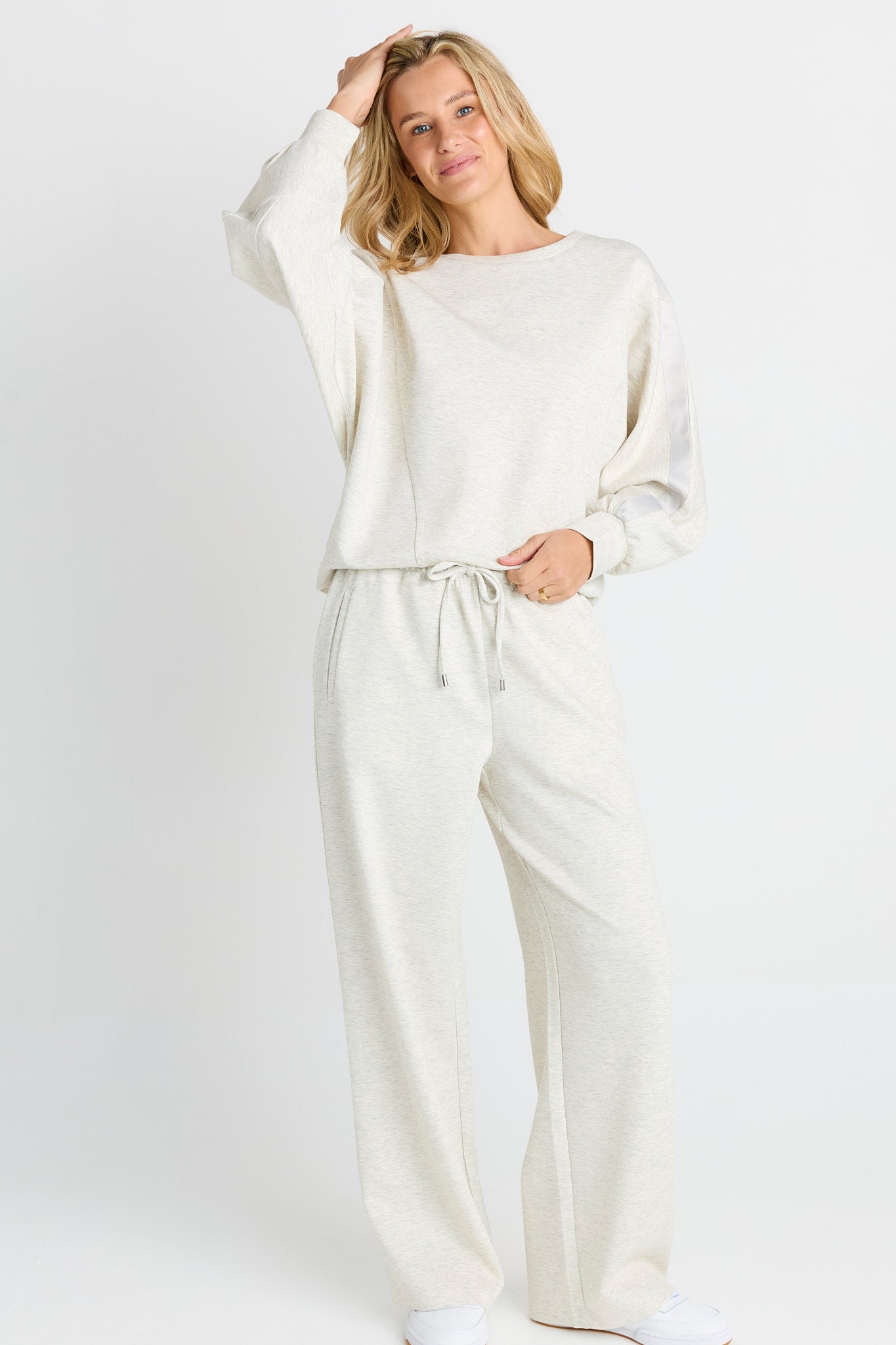 Image of a model wearing Pants. Product name - Marcy Trackpant Grey Marle in Grey Marle colour by brand - Betty Basics