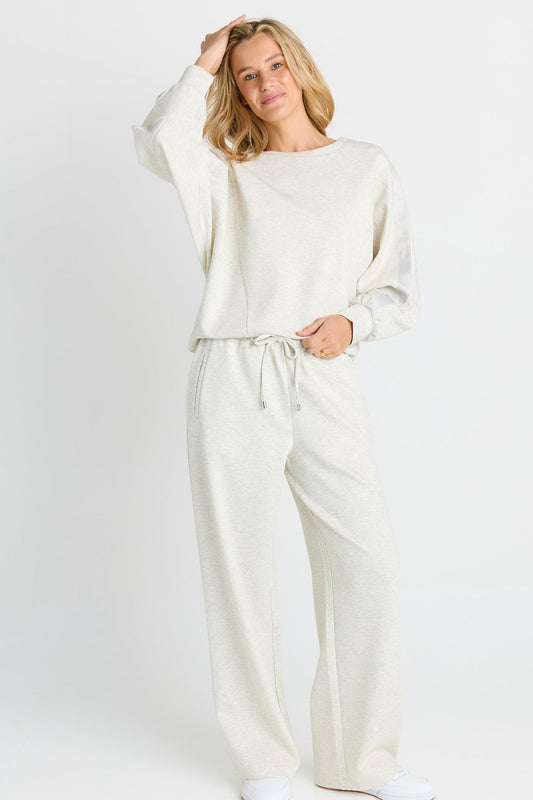 Image of a model wearing Pants. Product name - Marcy Trackpant Grey Marle in Grey Marle colour by brand - Betty Basics