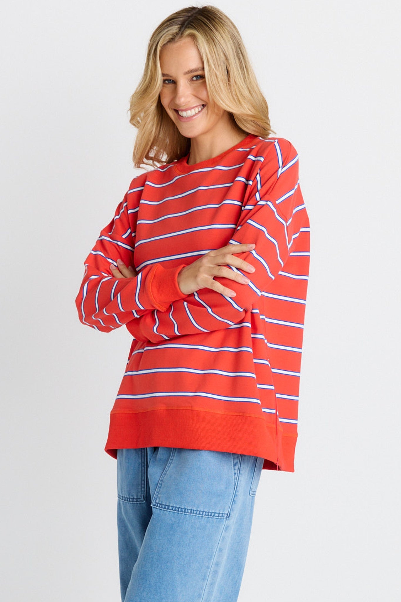 Image of a model wearing Outerwear. Product name - Ziggy Sweat Red/White Stripe in Red/White Stripe colour by brand - Betty Basics
