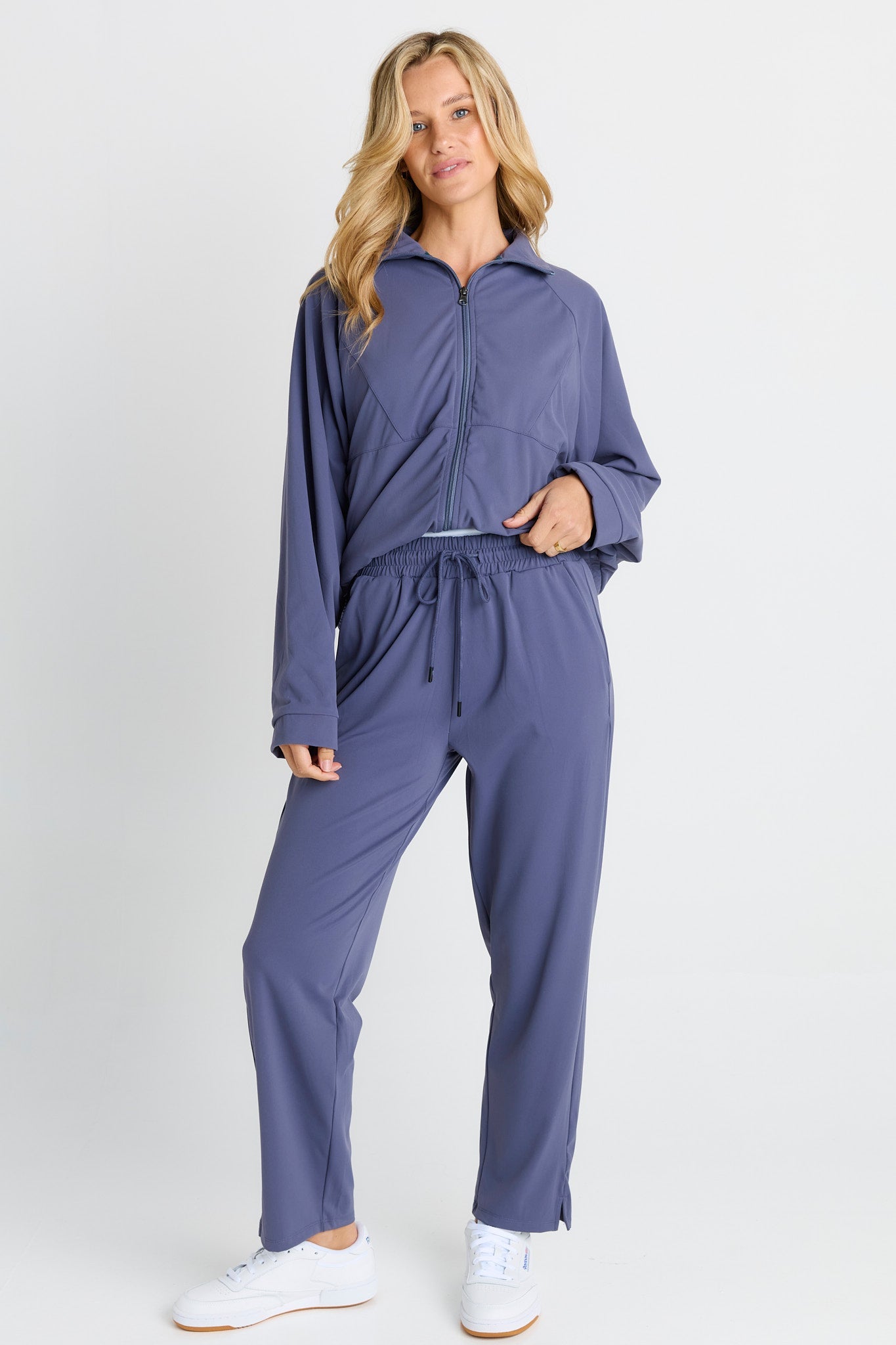 Image of a model wearing Pants. Product name - Milla Travel Jogger Steel Blue in Steel Blue colour by brand - Betty Basics