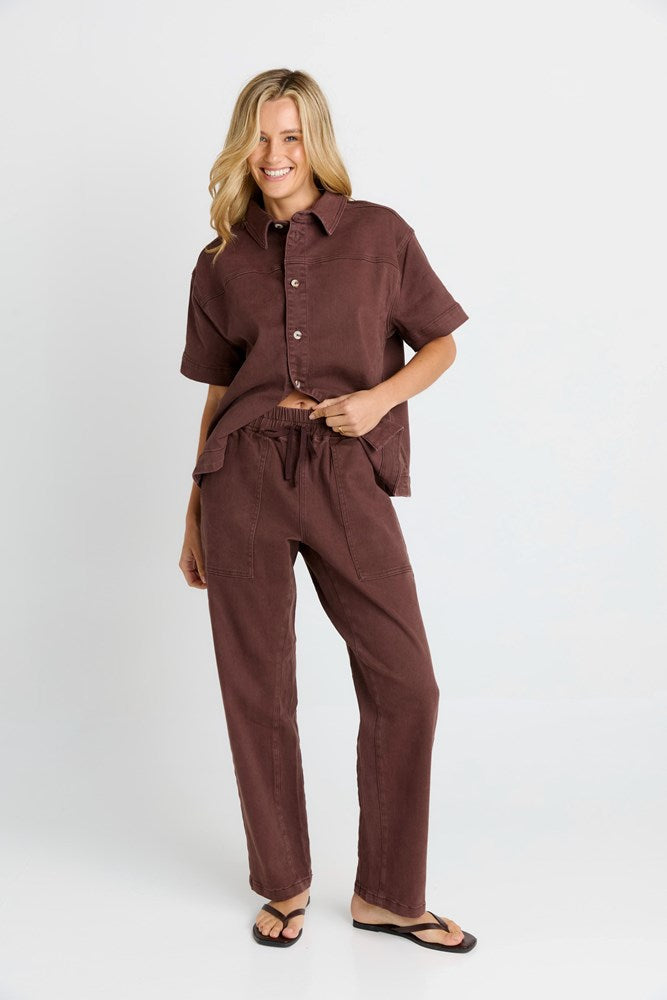 Image of a model wearing Pants. Product name - Quinn Cotton Jogger in Chocolate colour by brand - Betty Basics