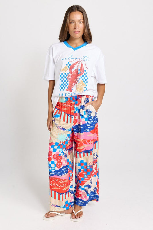 Image of a model wearing Pants. Product name - Sable Wide Leg Pant Mediterranean Print in Mediterranean Print colour by brand - Betty Basics
