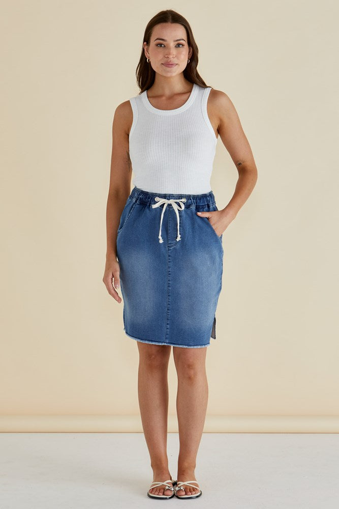 Image of a model wearing Skirts. Productname: Betty Basics Augie Denim Skirt Denim Blue in Denim Blue colour by brand - Betty Basics
