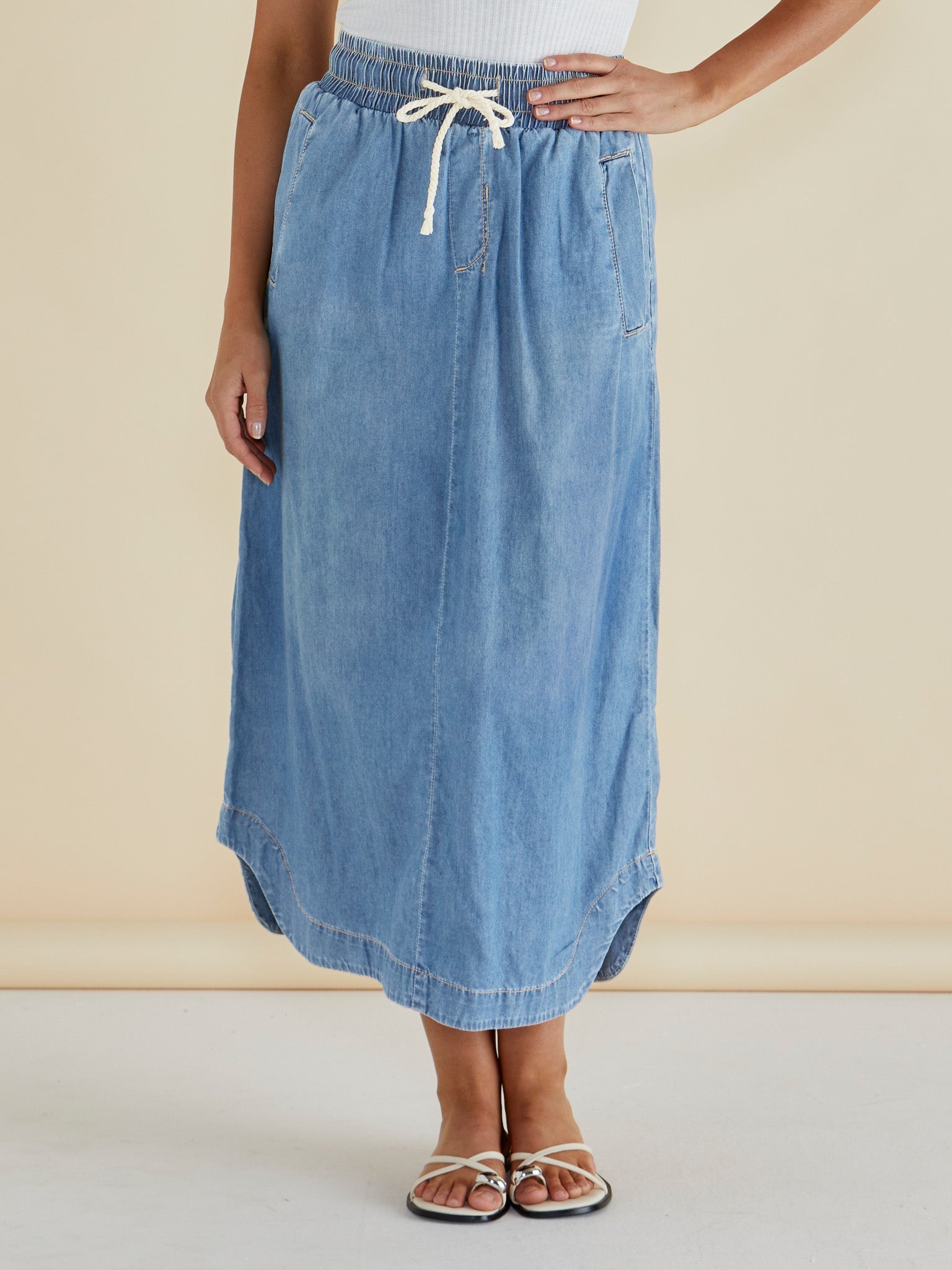 Image of a model wearing Skirts. Productname: Betty Basics Brunch Denim Skirt Oasis Blue in Oasis Blue colour by brand - Betty Basics