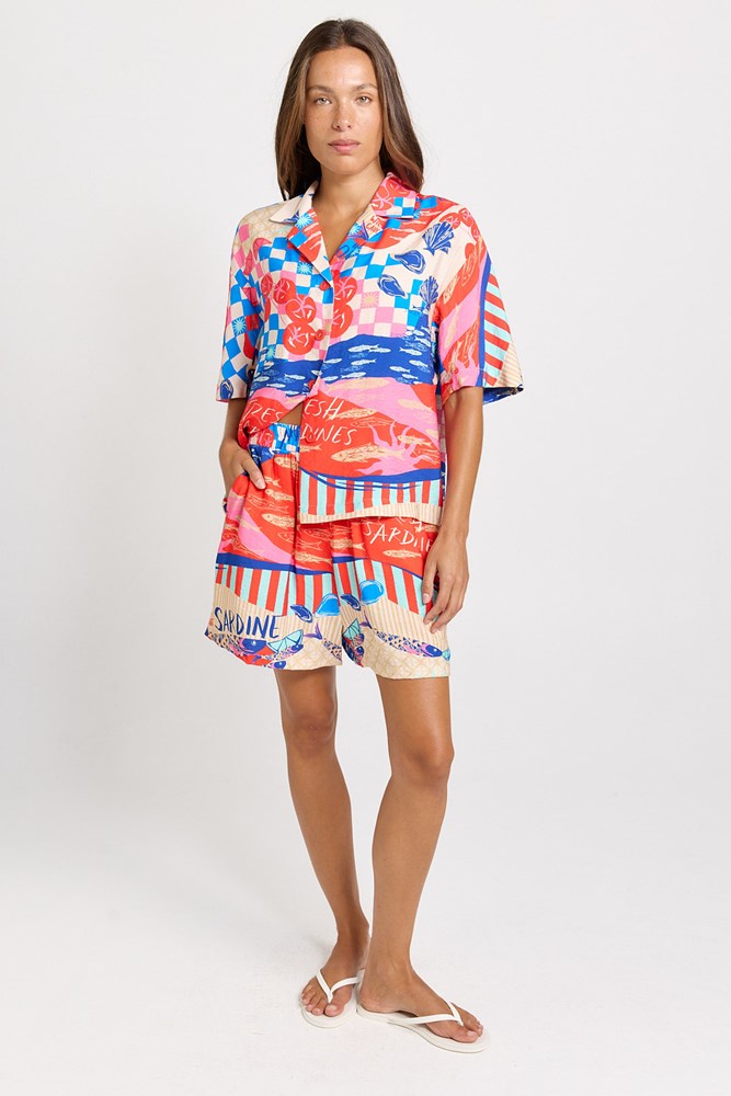 Image of a model wearing Shorts. Product name - Copacabana Short Mediterranean Print in Mediterranean Print colour by brand - Betty Basics