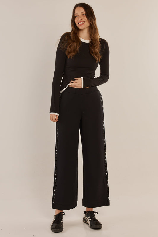 Image of a model wearing Pants. Product name - Bien Ponte Jogger Black/White in Black/White colour by brand - Betty Basics