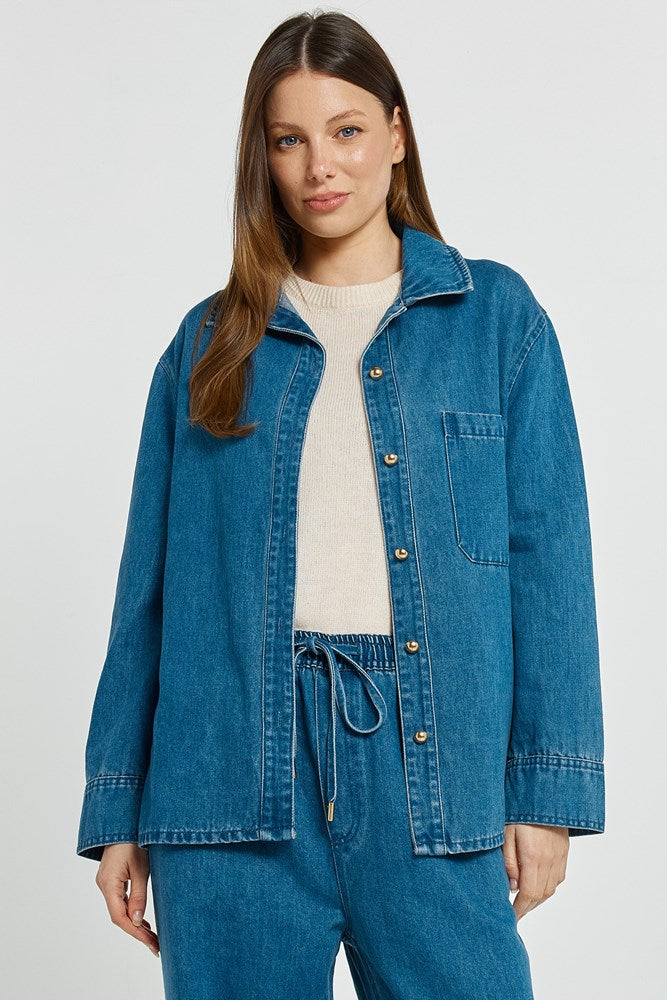 Image of a model wearing Tops. Product name - Vespa Denim Shirt Mid Blue in Mid Blue colour by brand - Betty Basics