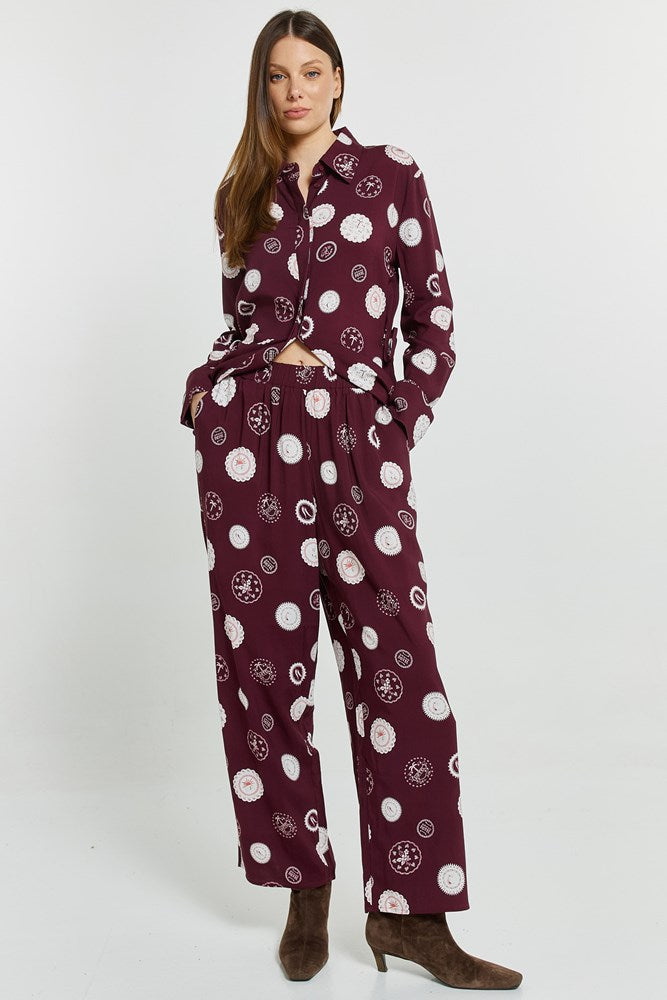 Image of a model wearing Pants. Product name - Stamp Relax Pants Postage Stamp Print in Postage Stamp Print colour by brand - Betty Basics