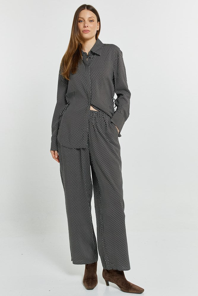Image of a model wearing Pants. Product name - Tessa Relax Pant Nutmeg Geo Print in Nutmeg Geo Print colour by brand - Betty Basics