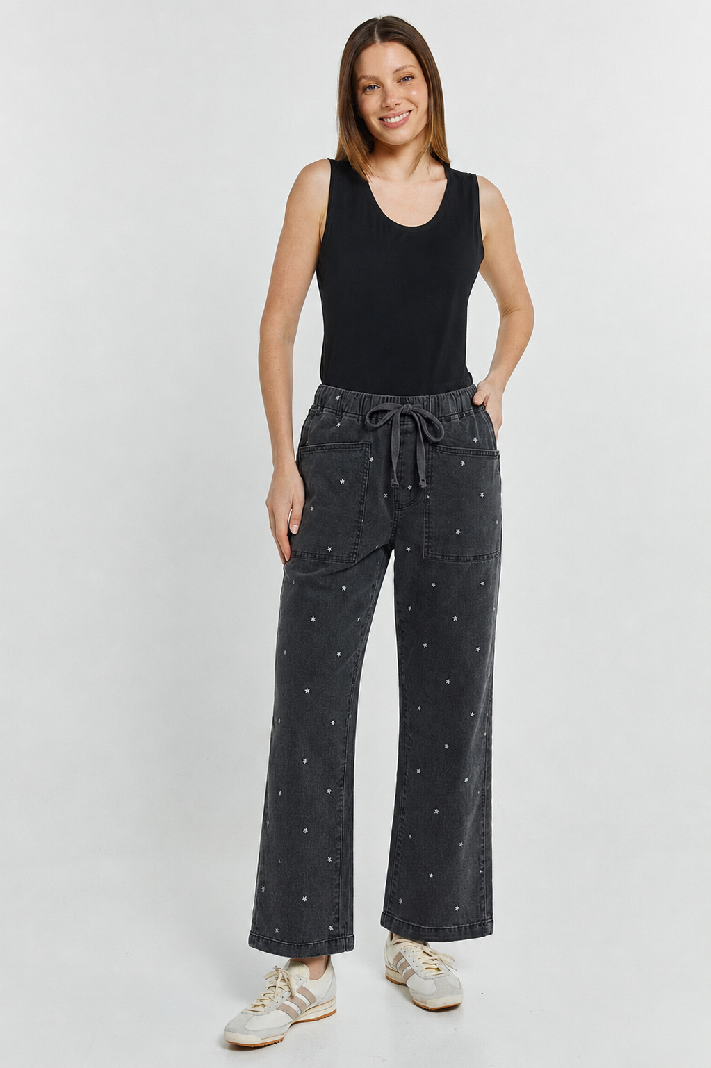 Image of a model wearing Pants. Product name - Quinn Stretch Jogger Star Print in Star Print colour by brand - Betty Basics