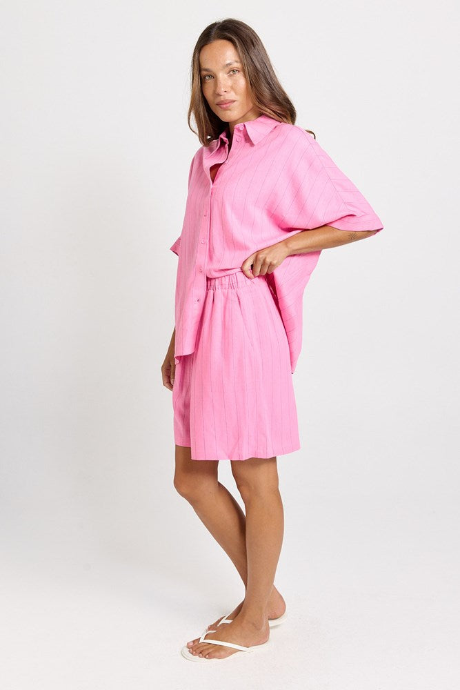 Image of a model wearing Shorts. Product name - Palm Linen Blend Relax Shorts Pink/Teal Stripe in Pink/Teal Stripe colour by brand - Betty Basics