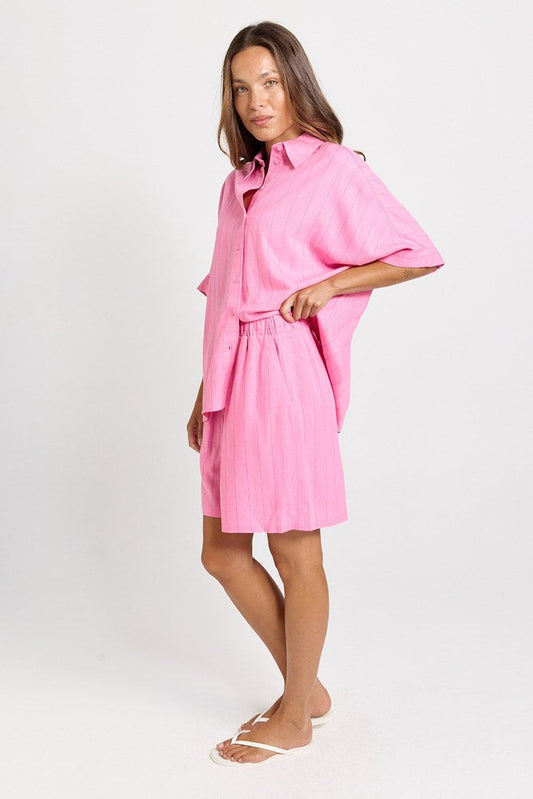Image of a model wearing Shorts. Product name - Palm Linen Blend Relax Shorts Pink/Teal Stripe in Pink/Teal Stripe colour by brand - Betty Basics