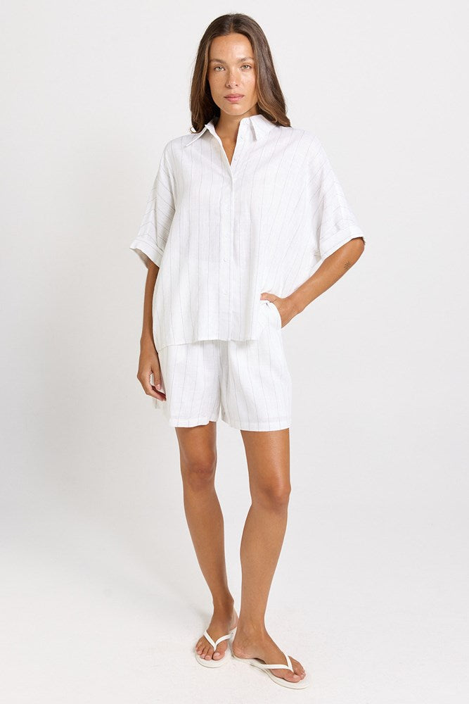 Image of a model wearing Shorts. Product name - Palm Linen Blend Relax Shorts White/Black Stripe in White/Black Stripe colour by brand - Betty Basics