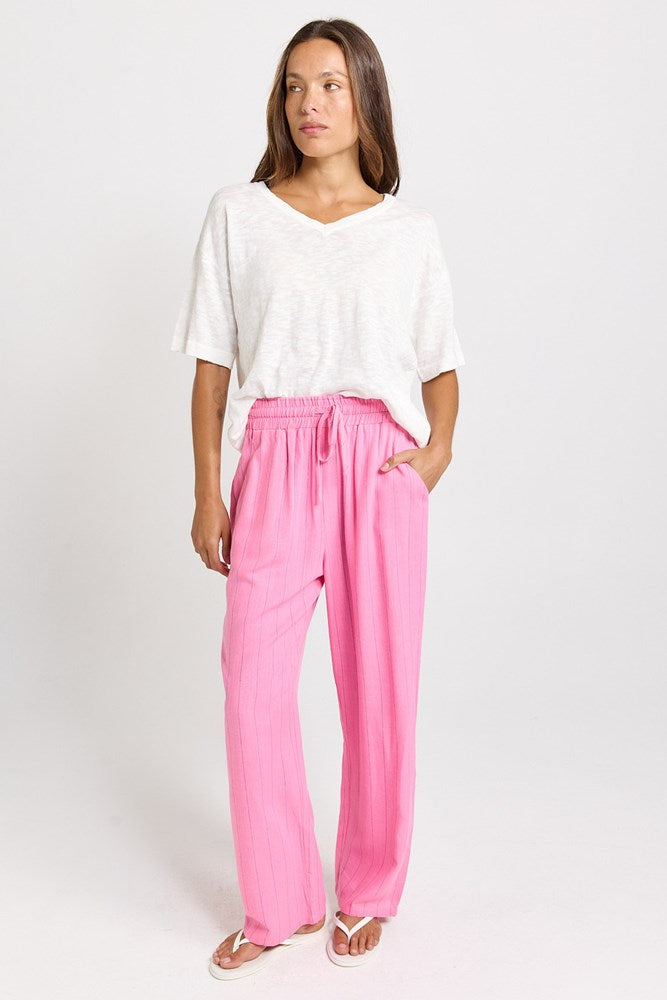 Image of a model wearing Pants. Product name - Palm Linen Blend Relax Pants Pink/Teal Stripe in Pink/Teal Stripe colour by brand - Betty Basics