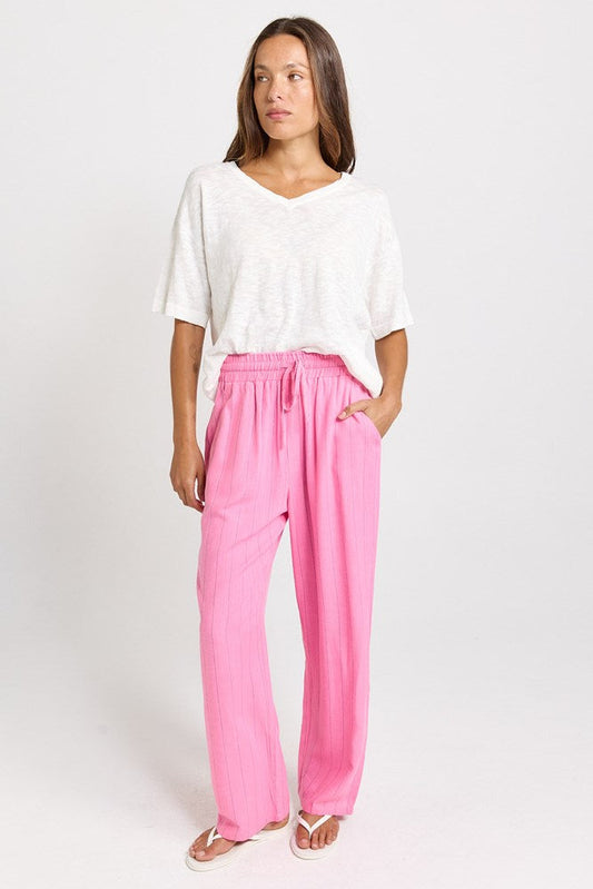 Image of a model wearing Pants. Product name - Palm Linen Blend Relax Pants Pink/Teal Stripe in Pink/Teal Stripe colour by brand - Betty Basics