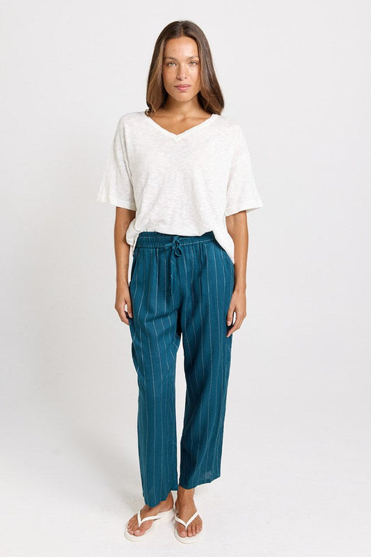Image of a model wearing Pants. Product name - Palm Linen Blend Relax Pants Teal/White Stripe in Teal/White Stripe colour by brand - Betty Basics