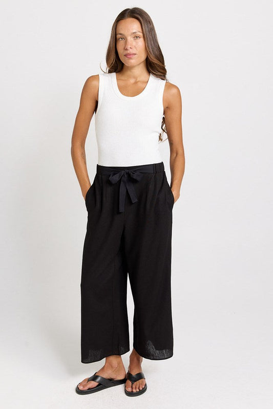 Image of a model wearing Pants. Product name - Bella Wide Leg Crop Pants Black in Black colour by brand - Betty Basics