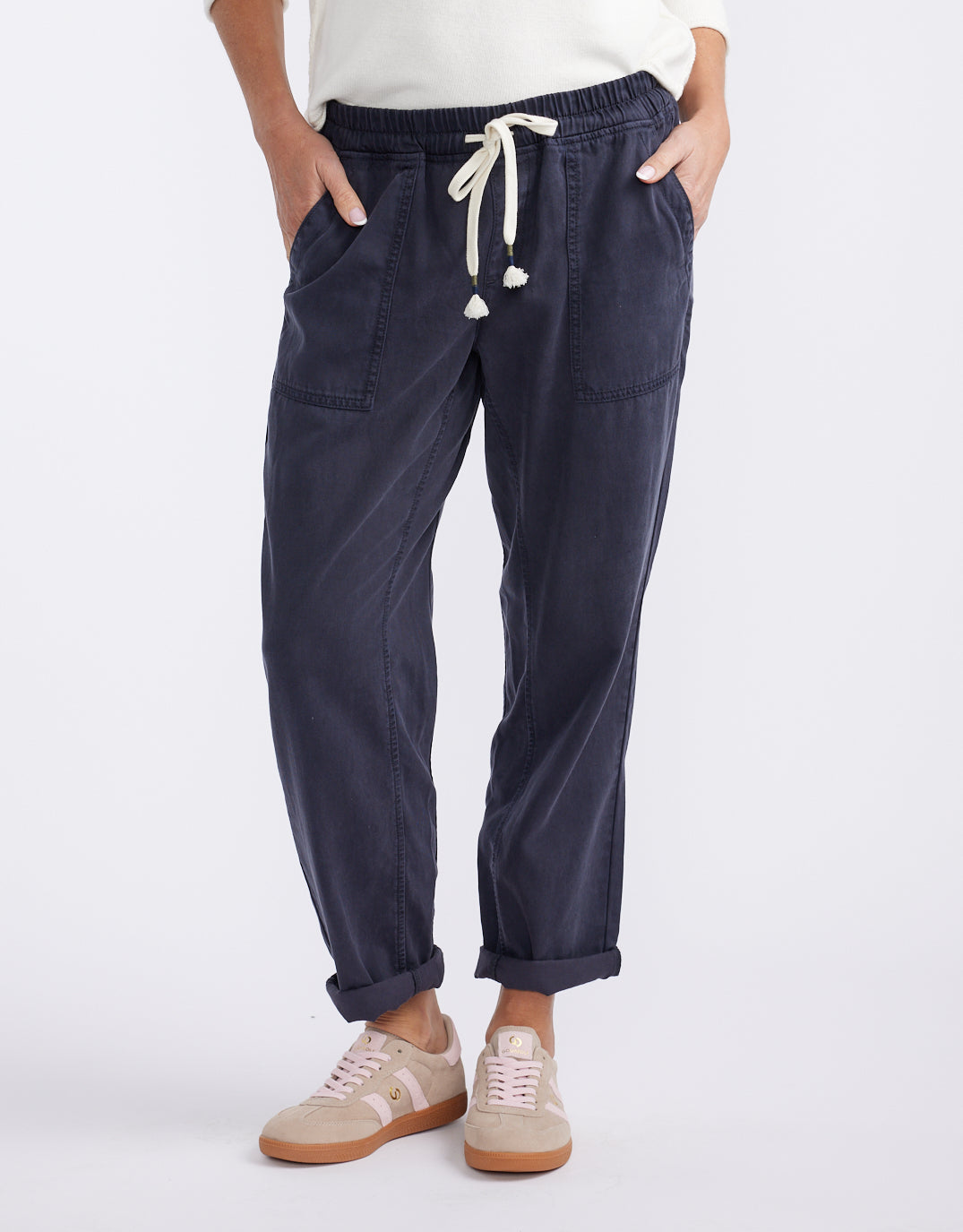 Image of a model wearing Pants. Product name - Beach Comber Pant Navy in Navy colour by brand - White & Co.