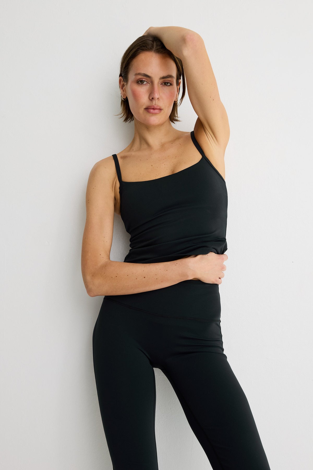 Image of a model wearing Tops. Product name - NEW ALLFENIX CloudCore Sculpt Tank in Black colour by brand - All Fenix