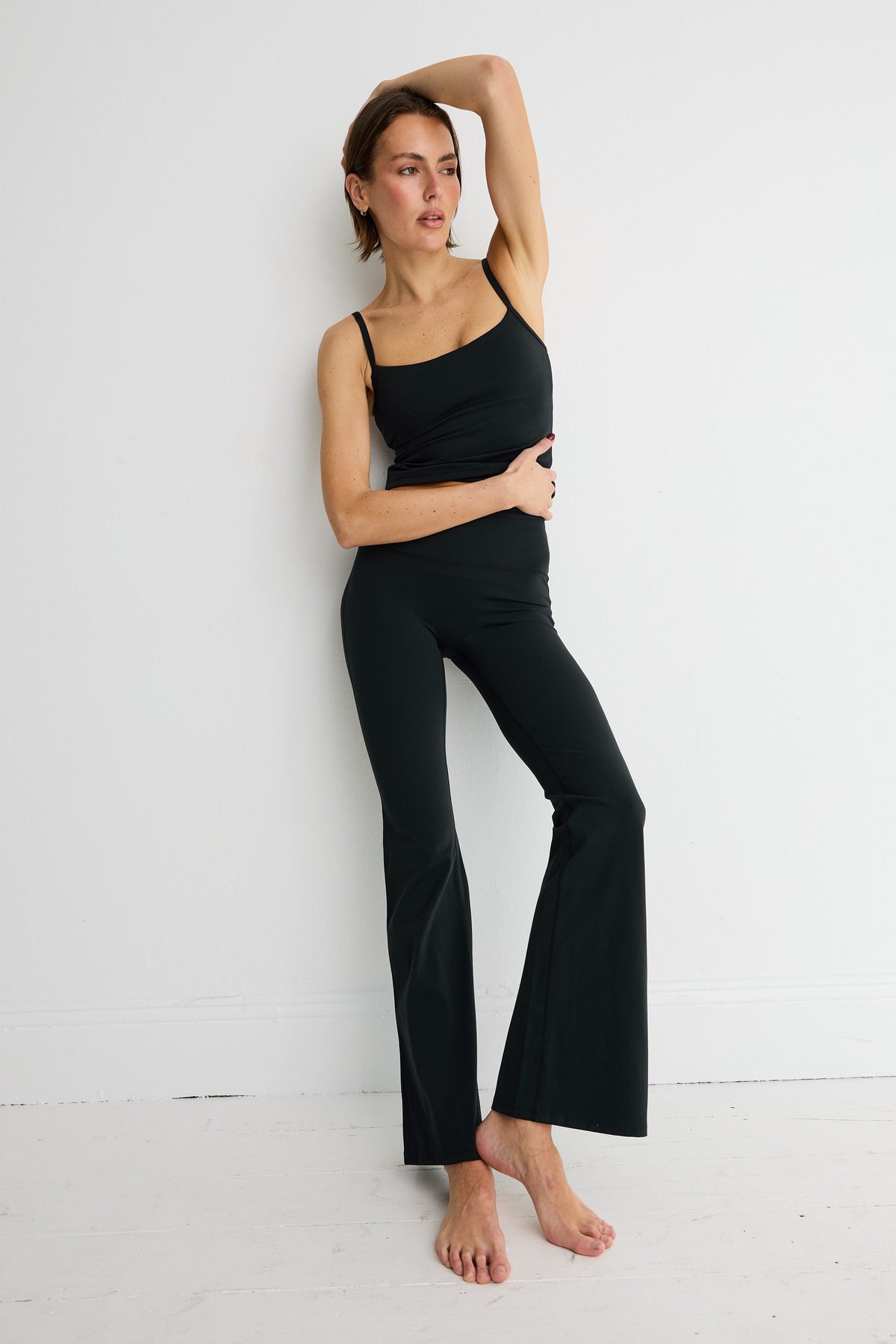 Image of a model wearing Pants. Product name - NEW ALLFENIX CloudCore Flared Legging in Black colour by brand - All Fenix