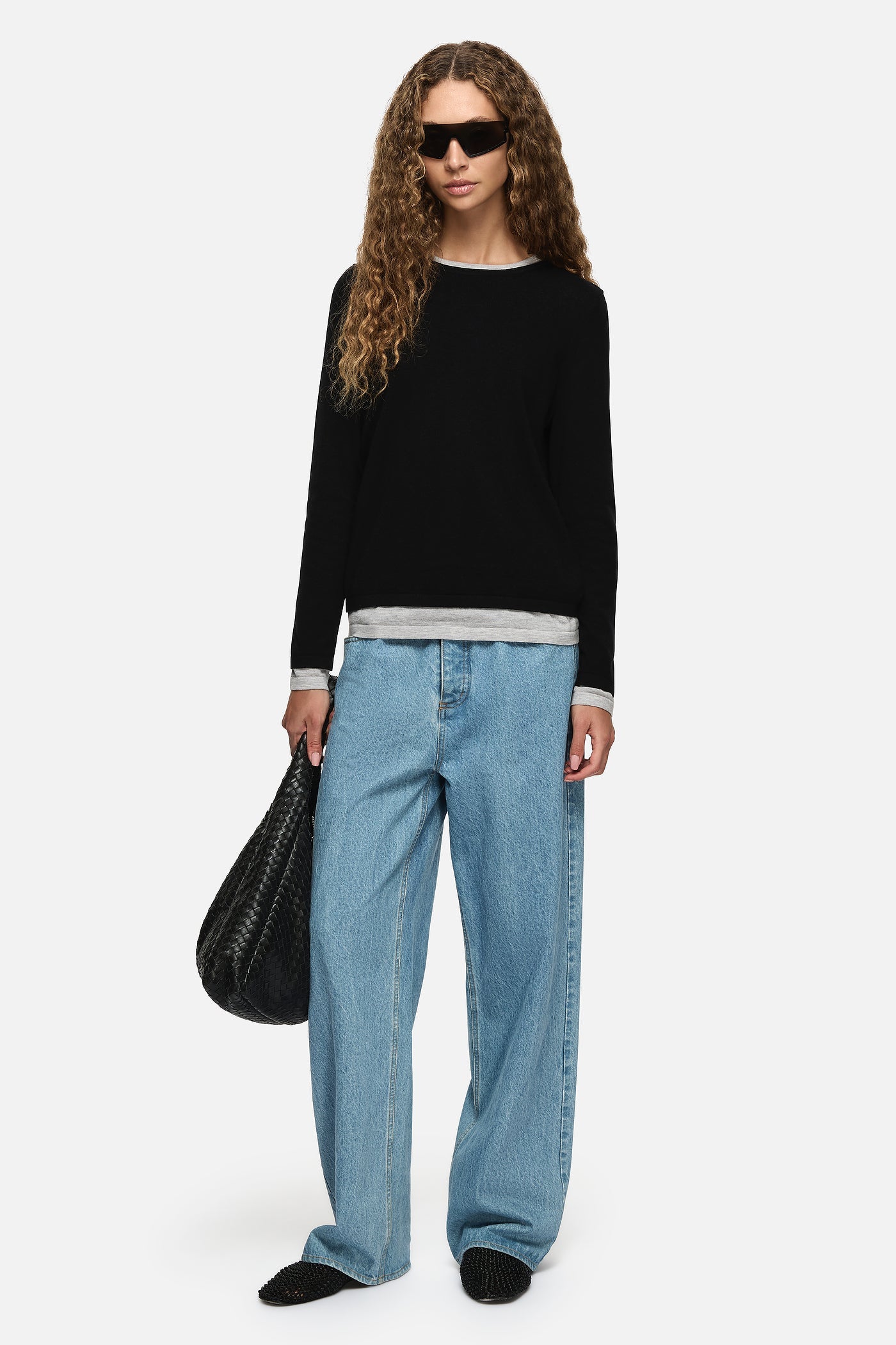 Image of a model wearing Outerwear. Product name - Amber Layered Sweater Black in Black colour by brand - Blanca Studio