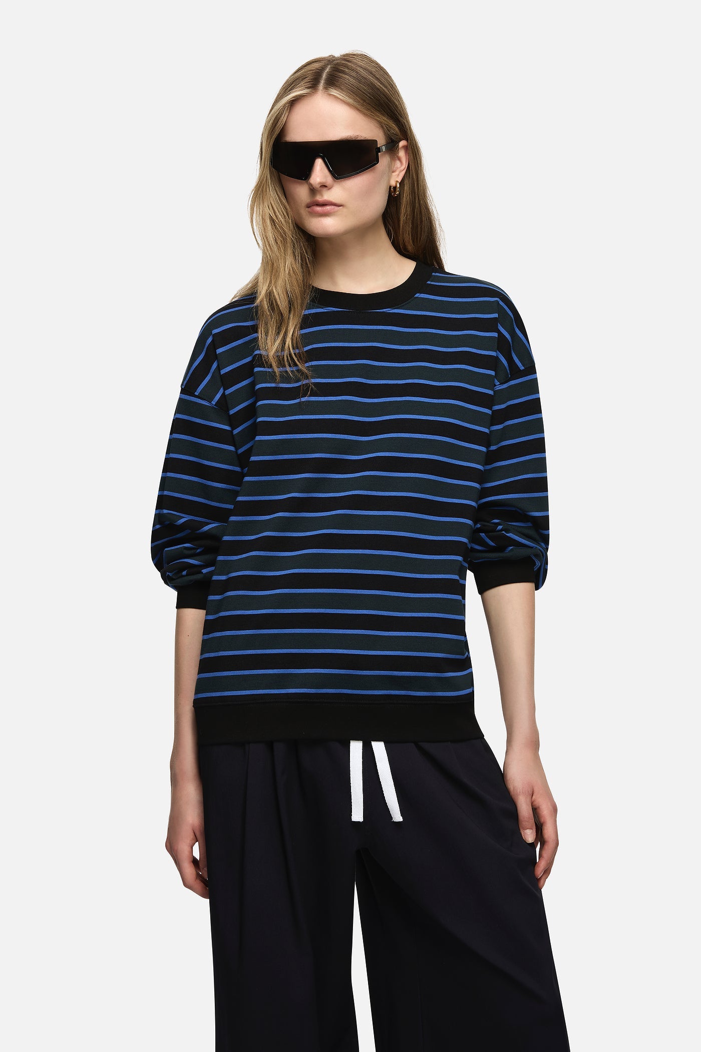 Image of a model wearing Tops. Product name - Bruna Sweater Blue in Blue colour by brand - Blanca Studio