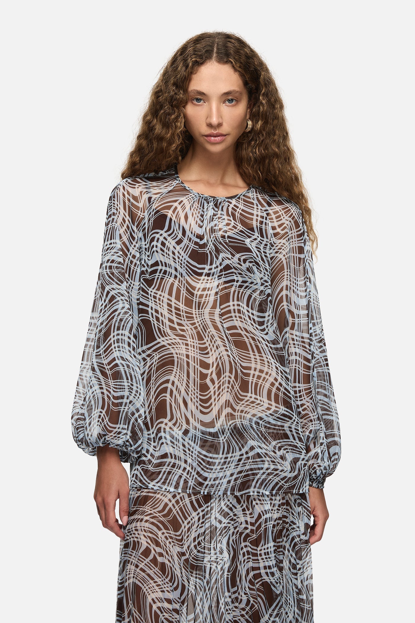 Image of a model wearing Tops. Product name - Domenica Top Blue in Blue colour by brand - Blanca Studio