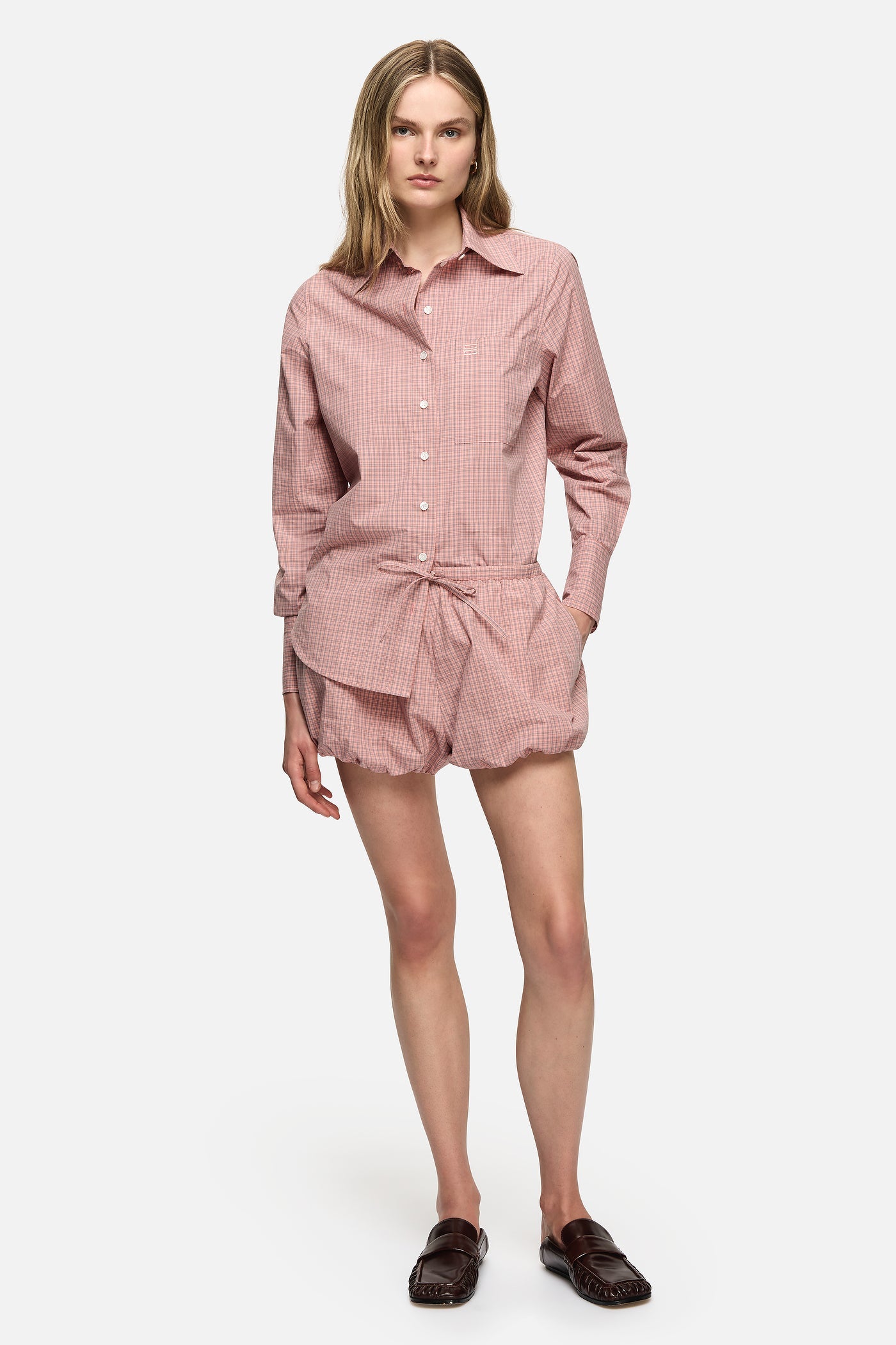 Image of a model wearing Shorts. Product name - Isley Shorts Pink in Pink colour by brand - Blanca Studio