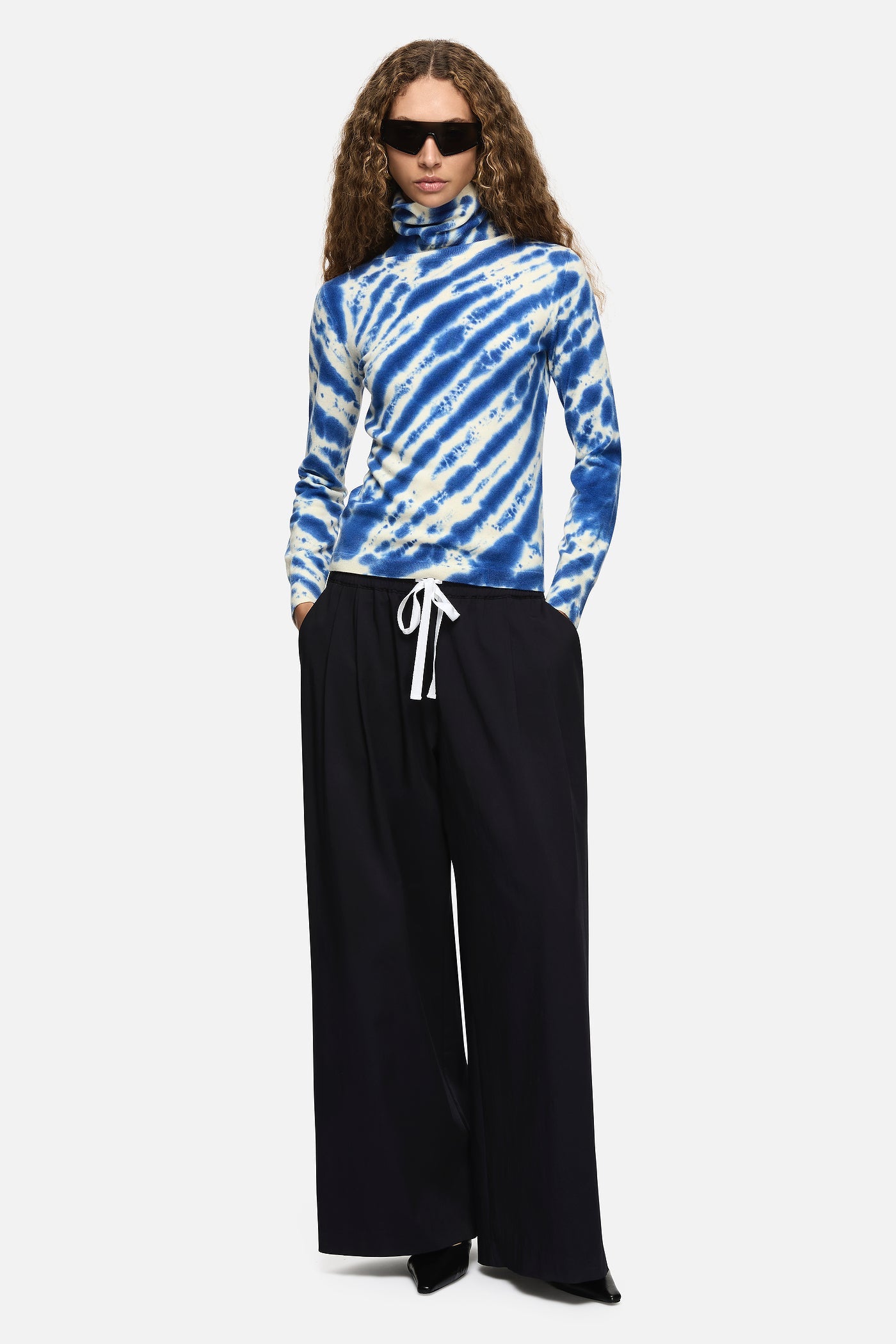 Image of a model wearing Tops. Product name - Paloma Turtleneck Blue in Blue colour by brand - Blanca Studio