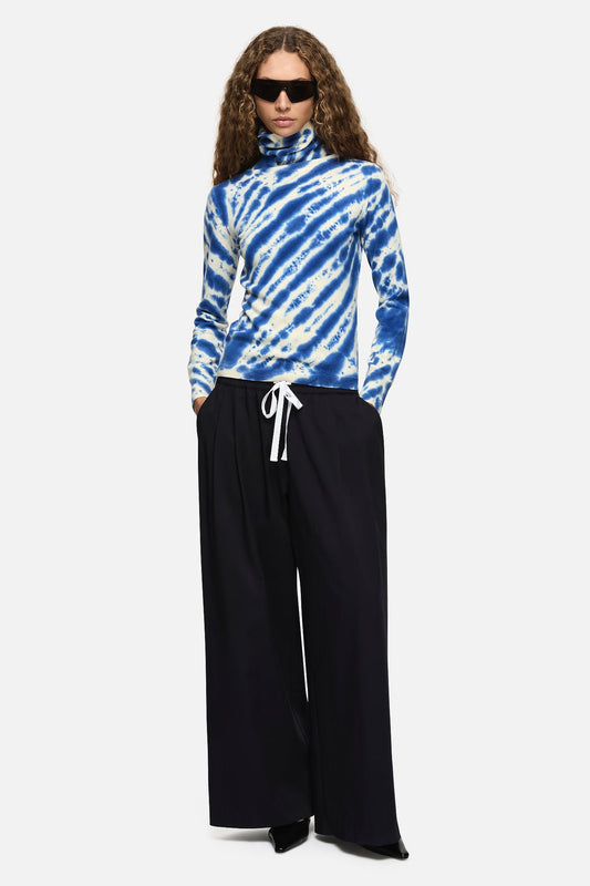 Image of a model wearing Tops. Product name - Paloma Turtleneck Blue in Blue colour by brand - Blanca Studio