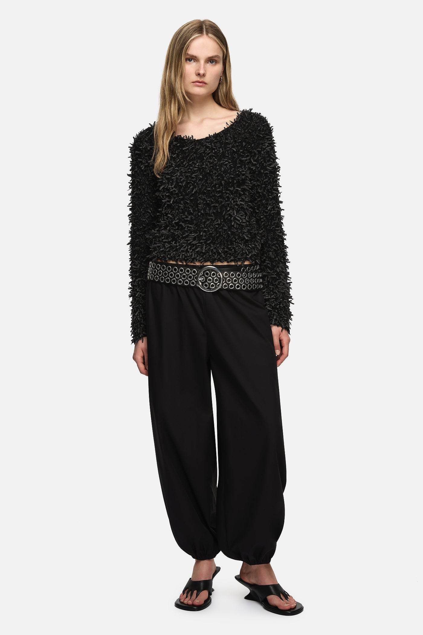 Image of a model wearing Outerwear. Product name - Paula Sweater Black in Black colour by brand - Blanca Studio