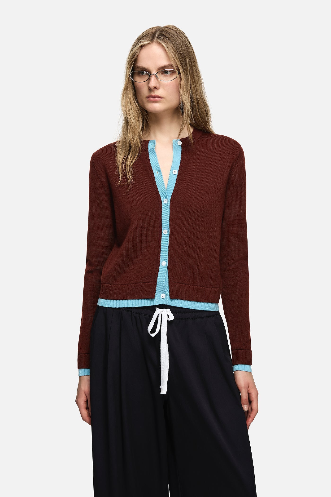 Image of a model wearing Outerwear. Product name - Roy Cardigan Brown in Brown colour by brand - Blanca Studio