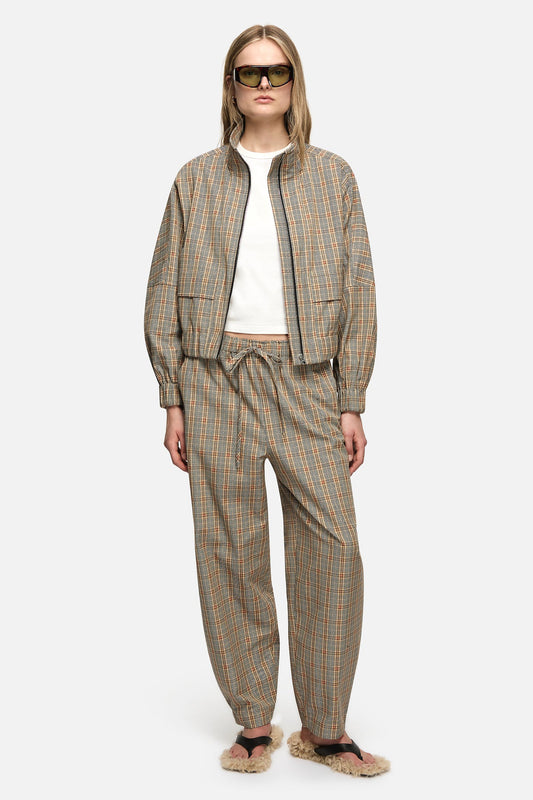 Image of a model wearing Pants. Product name - Sid Trousers Cream in Cream colour by brand - Blanca Studio