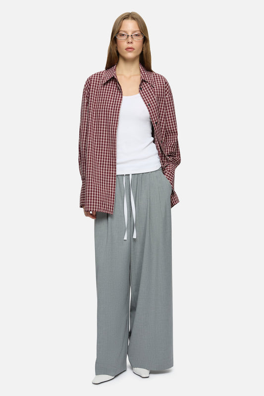 Image of a model wearing Pants. Product name - Mavis Trousers Grey in Grey colour by brand - Blanca Studio